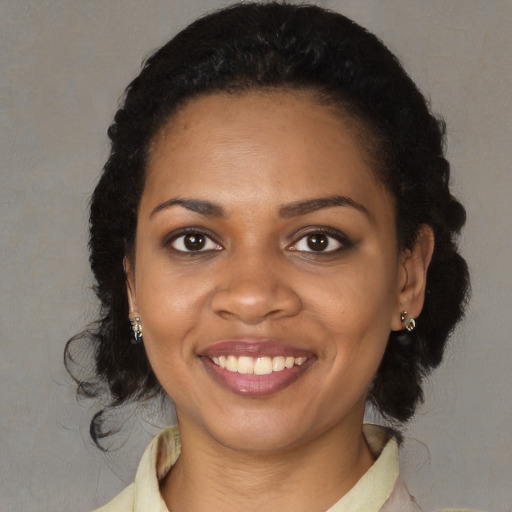 Joyful black young-adult female with medium  brown hair and brown eyes