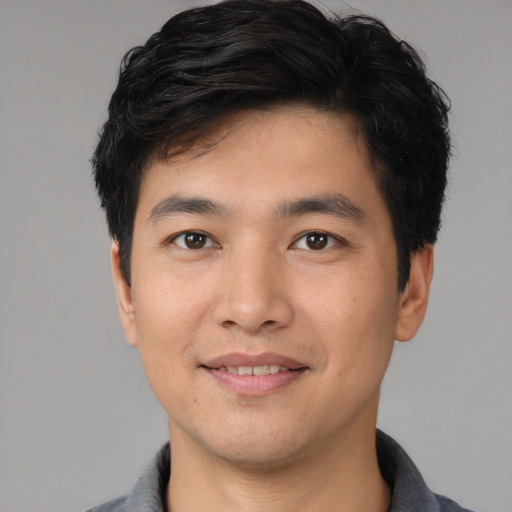Joyful white young-adult male with short  black hair and brown eyes