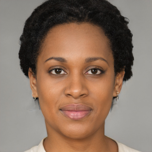 Joyful black young-adult female with short  brown hair and brown eyes