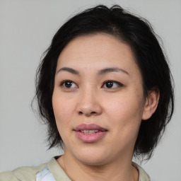 Joyful asian young-adult female with medium  brown hair and brown eyes