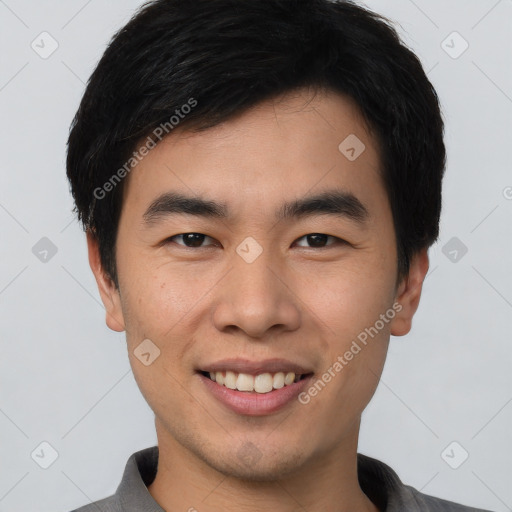 Joyful asian young-adult male with short  black hair and brown eyes