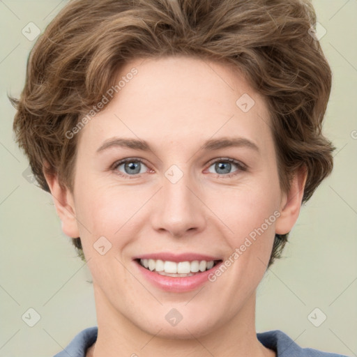 Joyful white young-adult female with short  brown hair and grey eyes