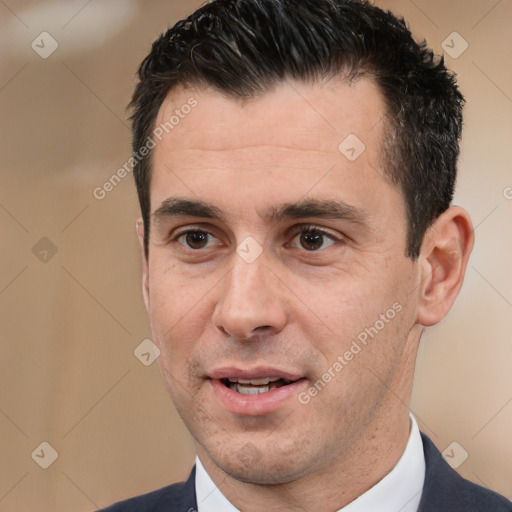 Joyful white adult male with short  black hair and brown eyes