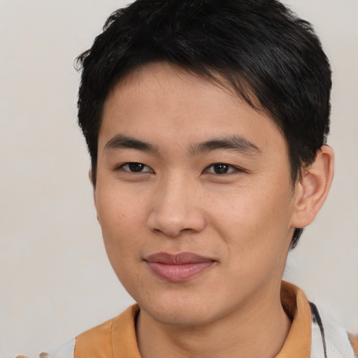 Joyful asian young-adult male with short  black hair and brown eyes
