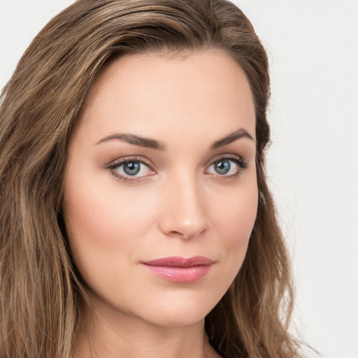 Joyful white young-adult female with long  brown hair and green eyes