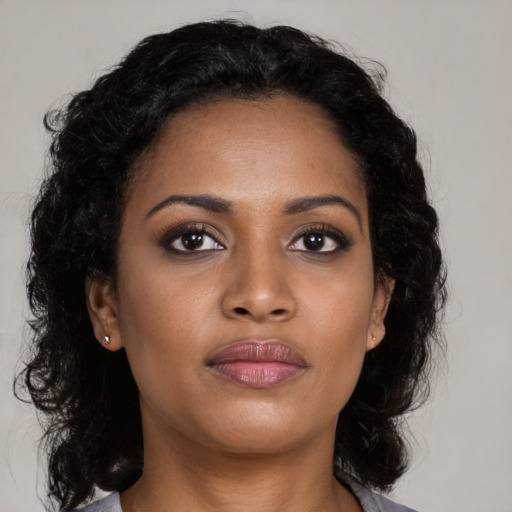 Joyful black young-adult female with medium  black hair and brown eyes