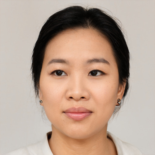 Joyful asian young-adult female with medium  black hair and brown eyes