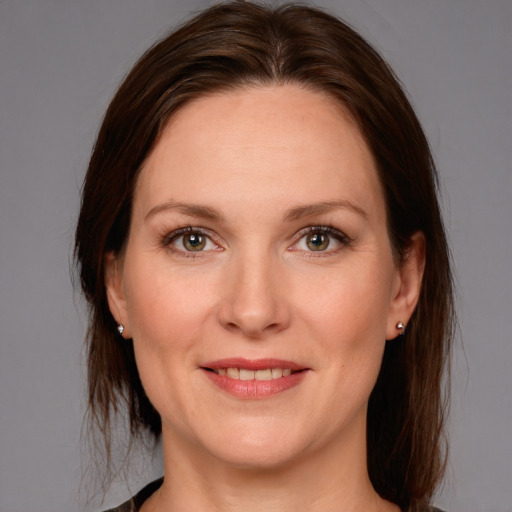 Joyful white adult female with medium  brown hair and grey eyes