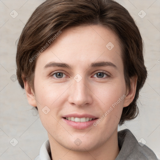 Joyful white young-adult female with short  brown hair and grey eyes