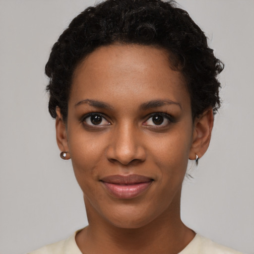 Joyful black young-adult female with short  black hair and brown eyes