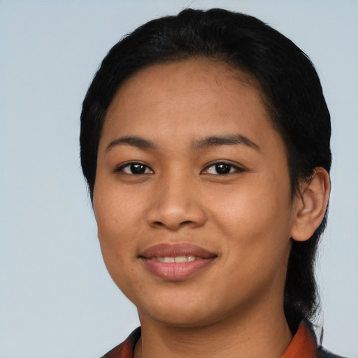 Joyful latino young-adult female with short  black hair and brown eyes