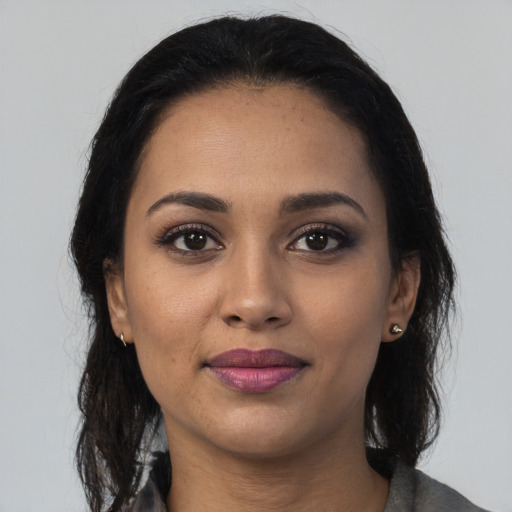 Joyful latino young-adult female with medium  black hair and brown eyes