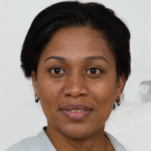 Joyful latino adult female with short  brown hair and brown eyes