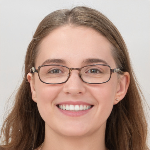 Joyful white young-adult female with long  brown hair and blue eyes