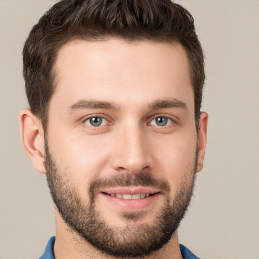 Joyful white young-adult male with short  brown hair and brown eyes