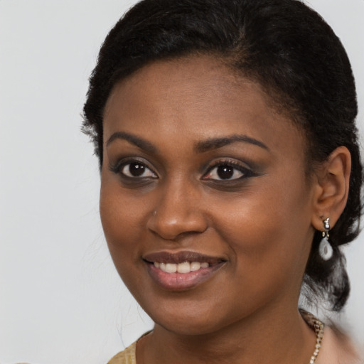 Joyful black young-adult female with long  brown hair and brown eyes