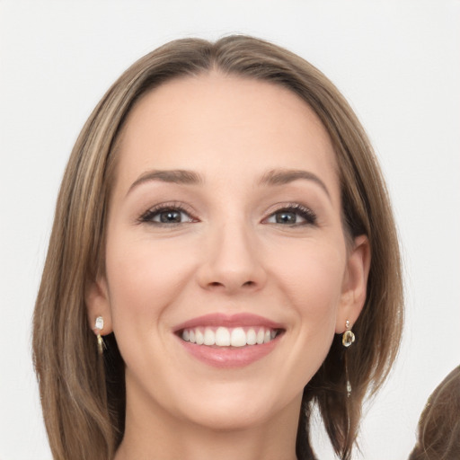 Joyful white young-adult female with long  brown hair and grey eyes