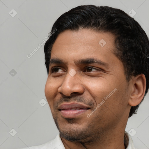 Joyful latino adult male with short  black hair and brown eyes