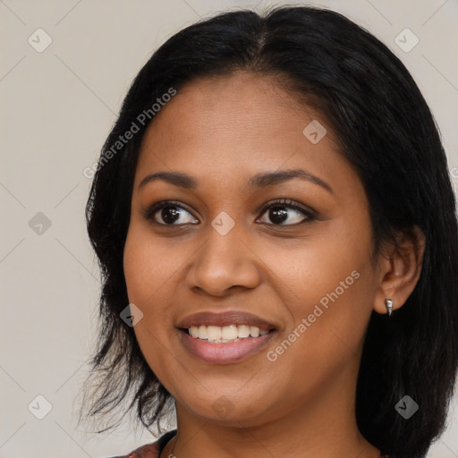 Joyful black young-adult female with medium  black hair and brown eyes