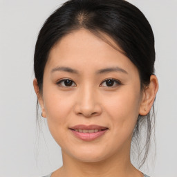 Joyful asian young-adult female with medium  brown hair and brown eyes