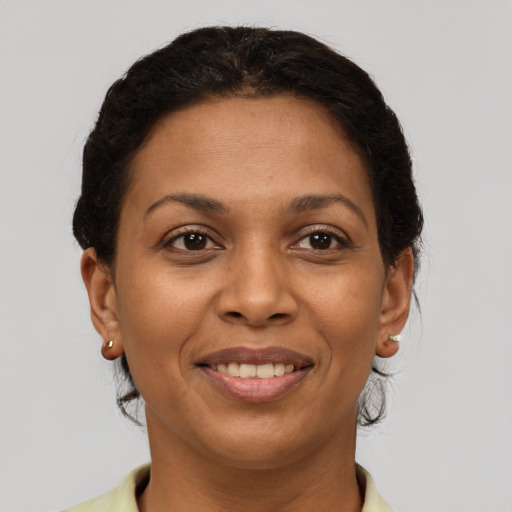Joyful latino adult female with short  brown hair and brown eyes