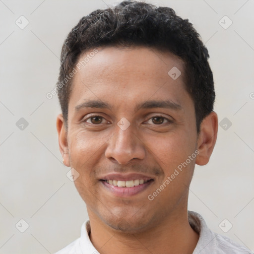 Joyful latino young-adult male with short  black hair and brown eyes