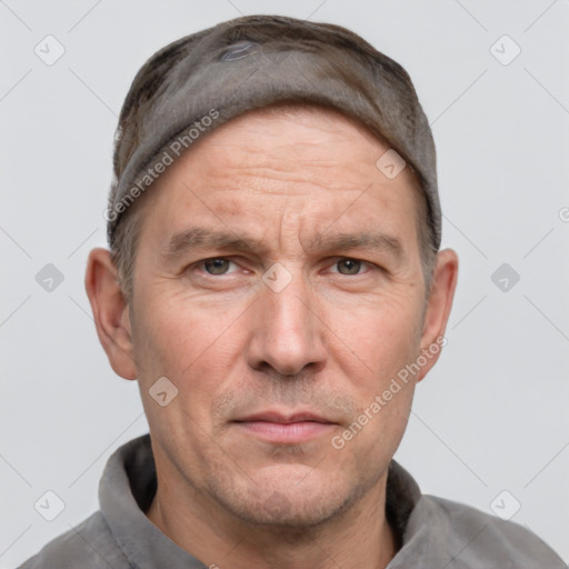 Joyful white adult male with short  brown hair and grey eyes