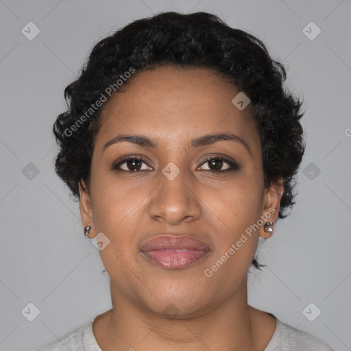 Joyful black young-adult female with short  black hair and brown eyes