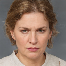 Joyful white adult female with medium  brown hair and grey eyes