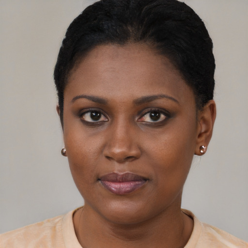 Joyful black young-adult female with short  black hair and brown eyes