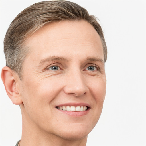 Joyful white adult male with short  brown hair and grey eyes