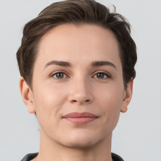 Joyful white young-adult female with short  brown hair and grey eyes