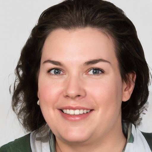 Joyful white young-adult female with medium  brown hair and green eyes