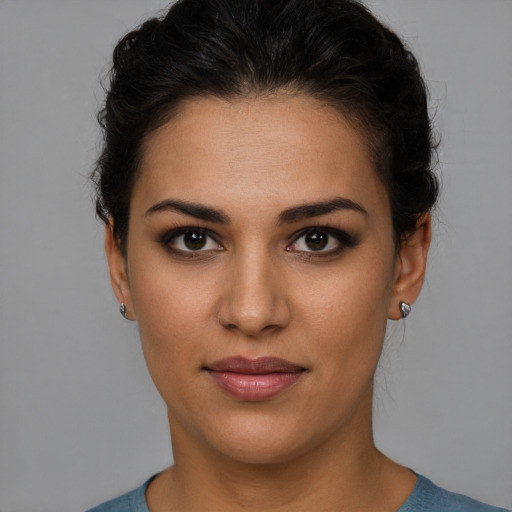 Joyful latino young-adult female with short  brown hair and brown eyes