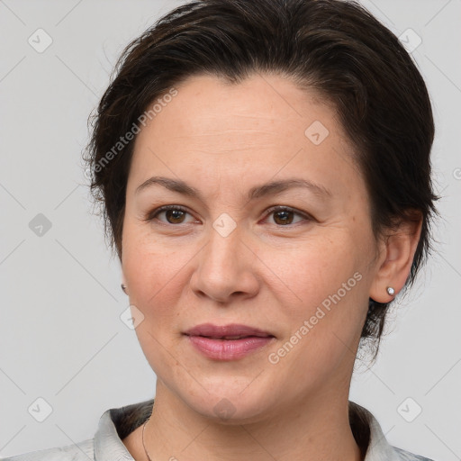 Joyful white adult female with medium  brown hair and brown eyes