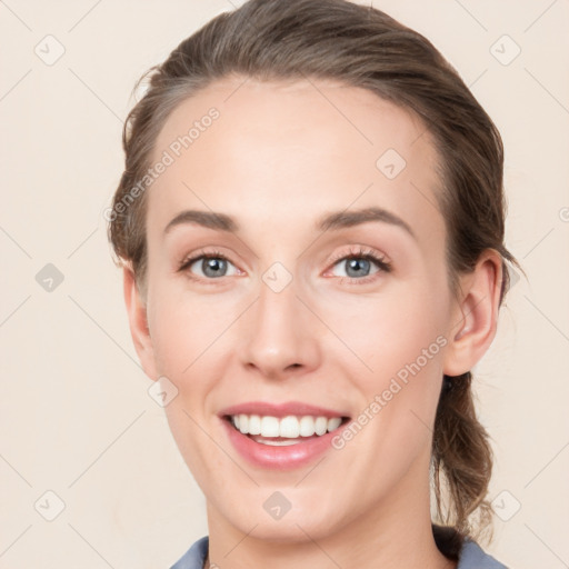 Joyful white young-adult female with medium  brown hair and blue eyes