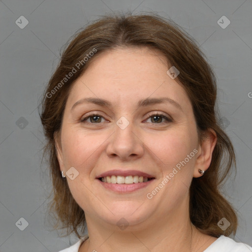 Joyful white adult female with medium  brown hair and grey eyes