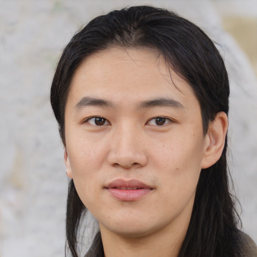 Joyful asian young-adult male with medium  black hair and brown eyes