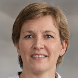 Joyful white adult female with medium  brown hair and grey eyes