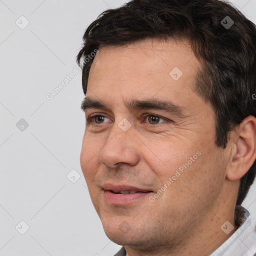 Joyful white adult male with short  black hair and brown eyes