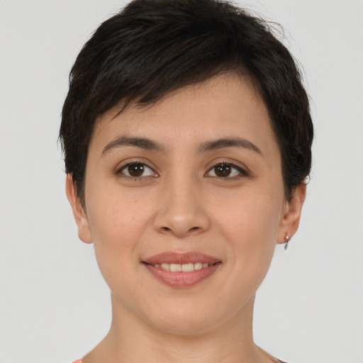 Joyful white young-adult female with short  brown hair and brown eyes