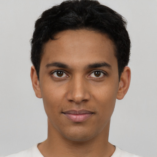Joyful latino young-adult male with short  black hair and brown eyes