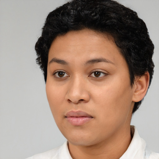 Joyful latino young-adult female with short  black hair and brown eyes