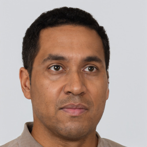 Neutral latino adult male with short  brown hair and brown eyes