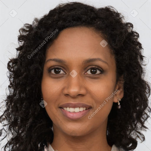 Joyful black young-adult female with long  brown hair and brown eyes