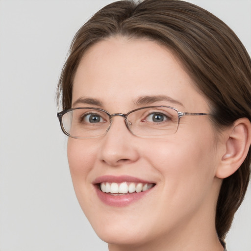 Joyful white adult female with medium  brown hair and grey eyes