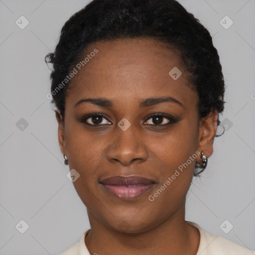 Joyful black young-adult female with short  black hair and brown eyes