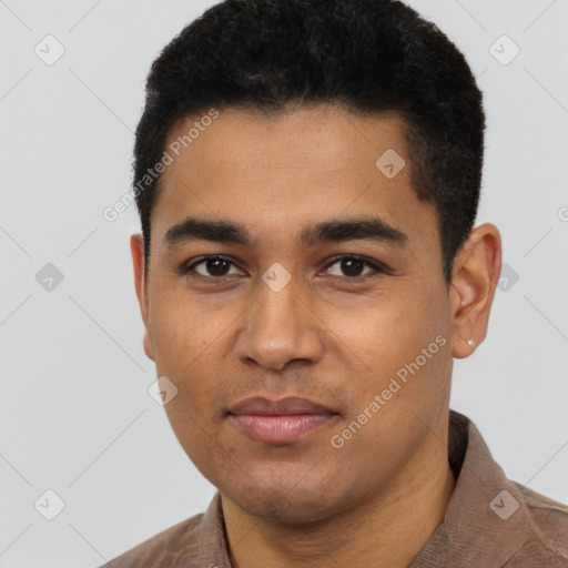 Joyful latino young-adult male with short  black hair and brown eyes