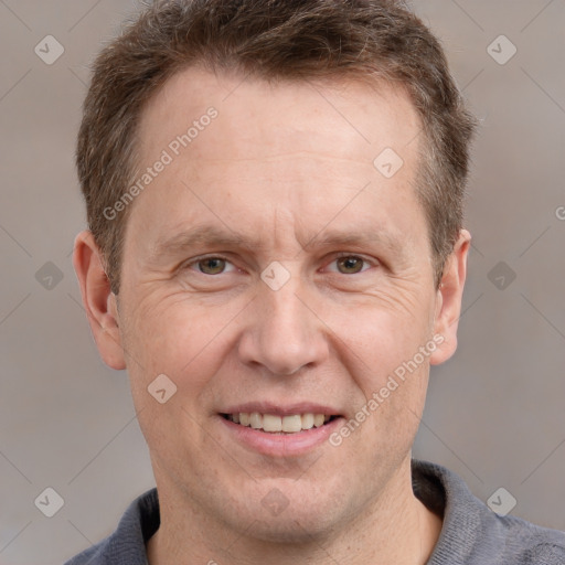 Joyful white adult male with short  brown hair and grey eyes