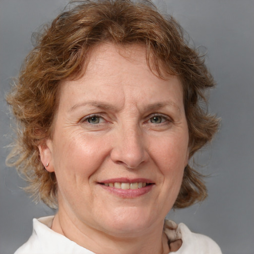 Joyful white middle-aged female with medium  brown hair and blue eyes